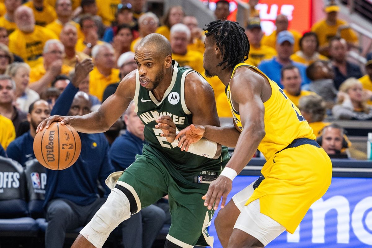 May 2, 2024; Indianapolis, Indiana, USA; Milwaukee Bucks forward Khris Middleton (22) dribbles the ball while Indiana Pacers forward Aaron Nesmith (23) defends during game six of the first round for the 2024 NBA playoffs at Gainbridge Fieldhouse. Mandatory Credit: Trevor Ruszkowski-Imagn Images