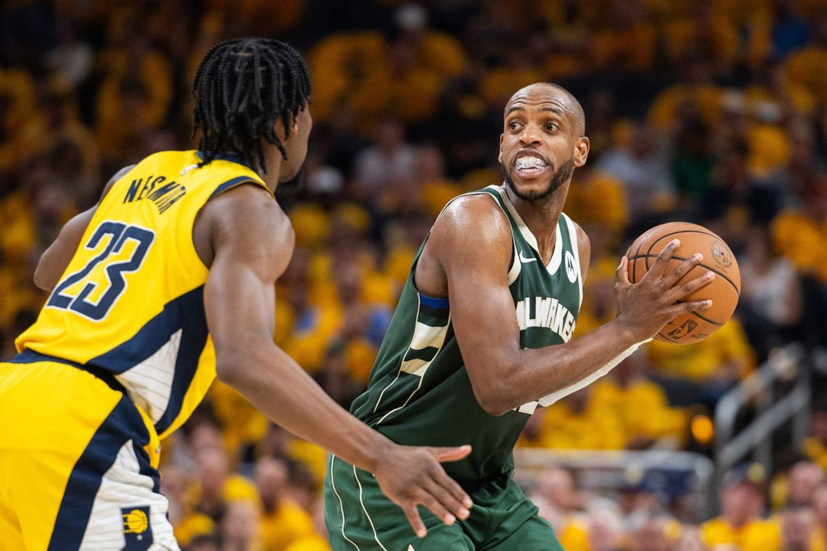 May 2, 2024; Indianapolis, Indiana, USA; Milwaukee Bucks forward Khris Middleton (22) holds the ball while  Indiana Pacers forward Aaron Nesmith (23) defends during game six of the first round for the 2024 NBA playoffs at Gainbridge Fieldhouse. Mandatory Credit: Trevor Ruszkowski-Imagn Images