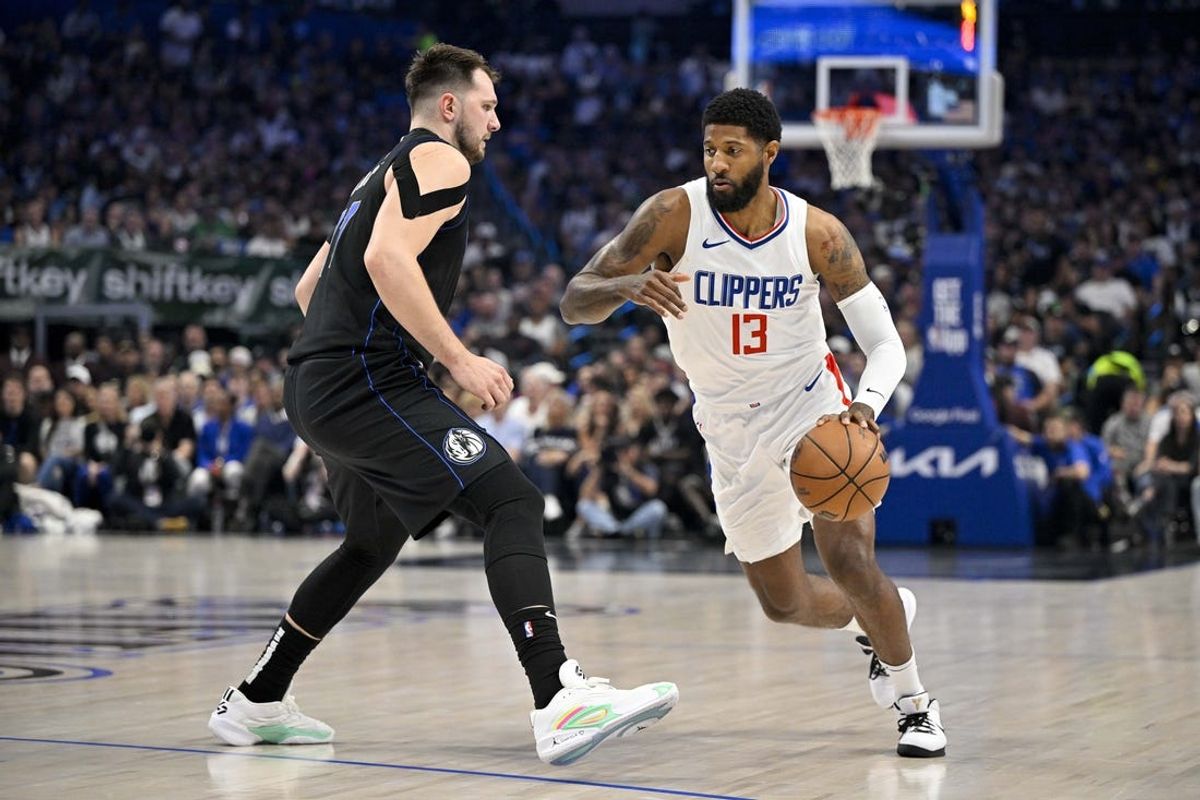 May 3, 2024; Dallas, Texas, USA; LA Clippers forward Paul George (13) moves the ball past Dallas Mavericks guard Luka Doncic (77) during the first quarter during game six of the first round for the 2024 NBA playoffs at American Airlines Center. Mandatory Credit: Jerome Miron-USA TODAY Sports