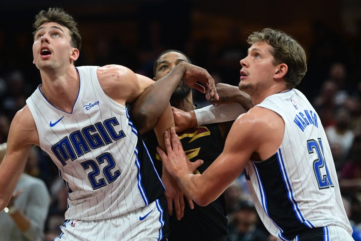 May 5, 2024; Cleveland, Ohio, USA; Orlando Magic forward Franz Wagner (22) and center Moritz Wagner (21) fight for position with Cleveland Cavaliers center Tristan Thompson (13) during the second half in game seven of the first round for the 2024 NBA playoffs at Rocket Mortgage FieldHouse. Mandatory Credit: Ken Blaze-Imagn Images