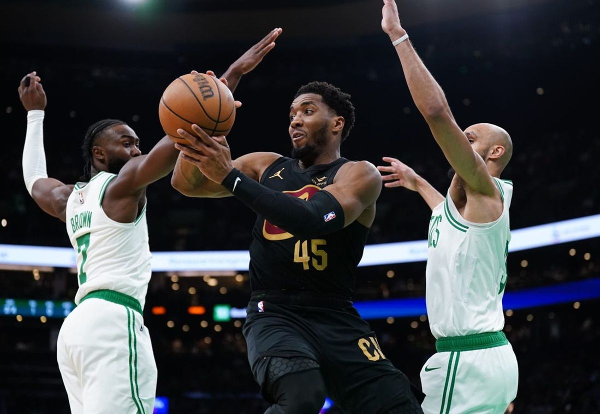 May 9, 2024; Boston, Massachusetts, USA; Cleveland Cavaliers guard Donovan Mitchell (45) passes the ball against Boston Celtics guard Jaylen Brown (7) and guard Derrick White (9) in the first quarter during game two of the second round for the 2024 NBA playoffs at TD Garden. Mandatory Credit: David Butler II-USA TODAY Sports
