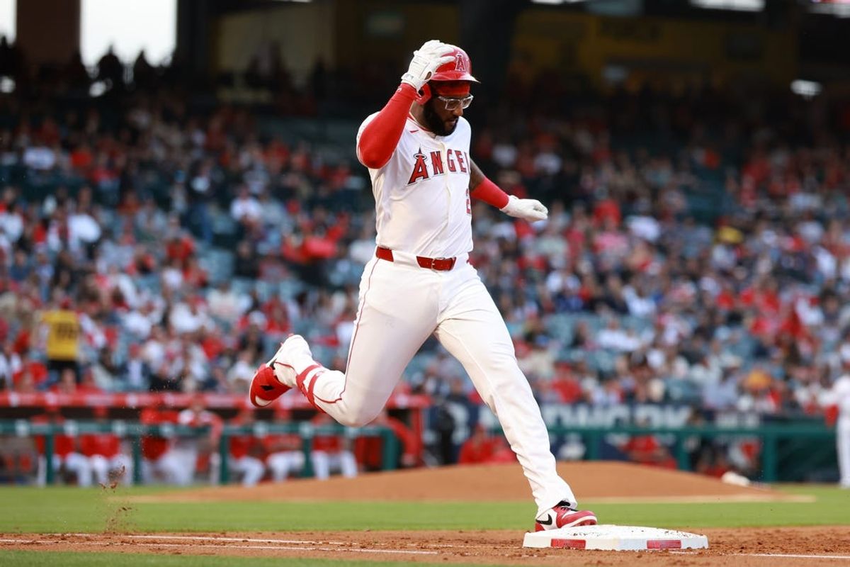 May 10, 2024; Anaheim, California, USA;  Los Angeles Angels third base Niko Goodrum (28) reaches first base on an error during the second inning against the Kansas City Royals at Angel Stadium. Mandatory Credit: Kiyoshi Mio-USA TODAY Sports