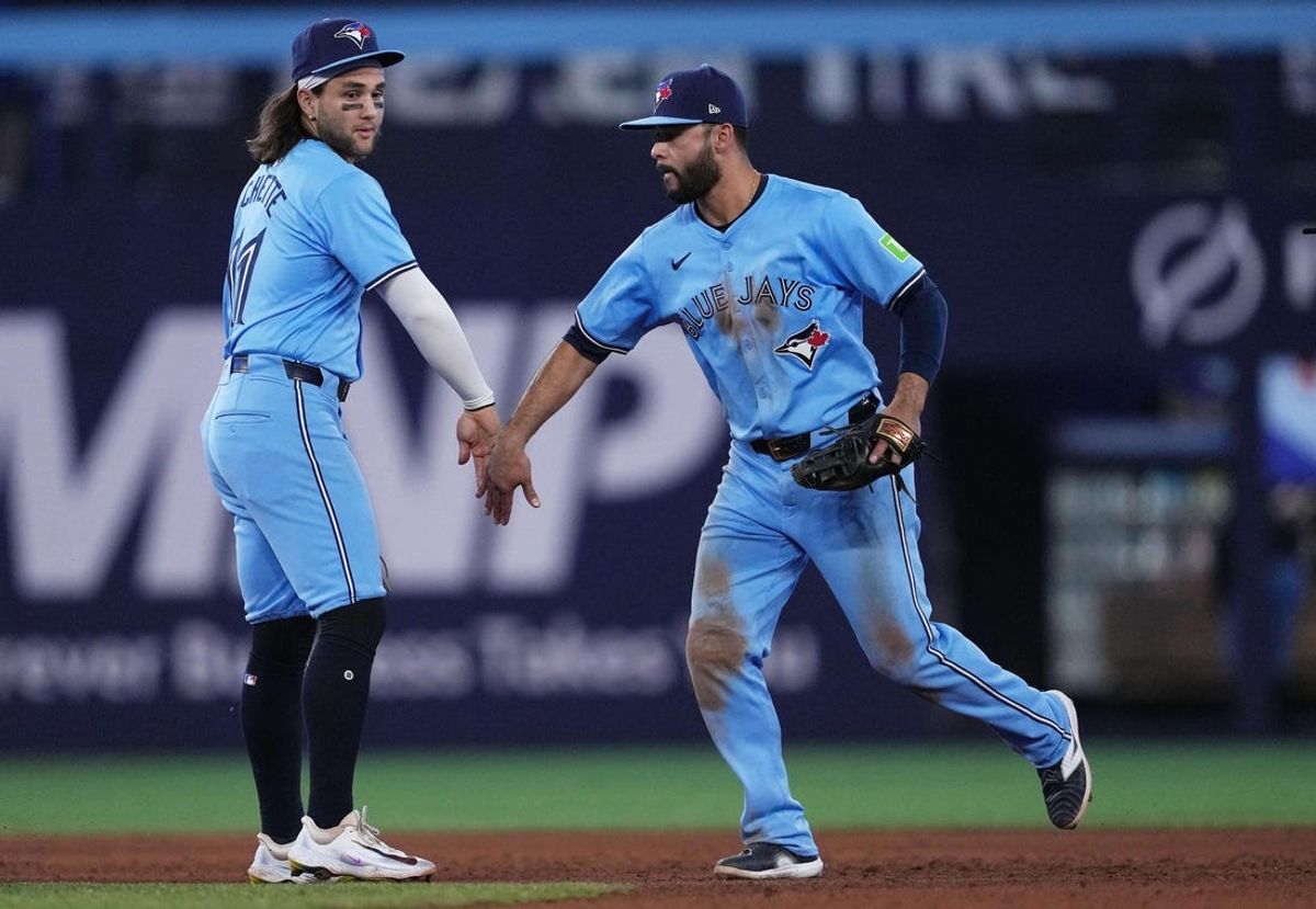 May 11, 2024; Toronto, Ontario, CAN; Toronto Blue Jays shortstop Bo Bichette (11) celebrates the win with second baseman Isiah Kiner-Falefa (7) at the end of the ninth inning against the Minnesota Twins at Rogers Centre. Mandatory Credit: Nick Turchiaro-USA TODAY Sports