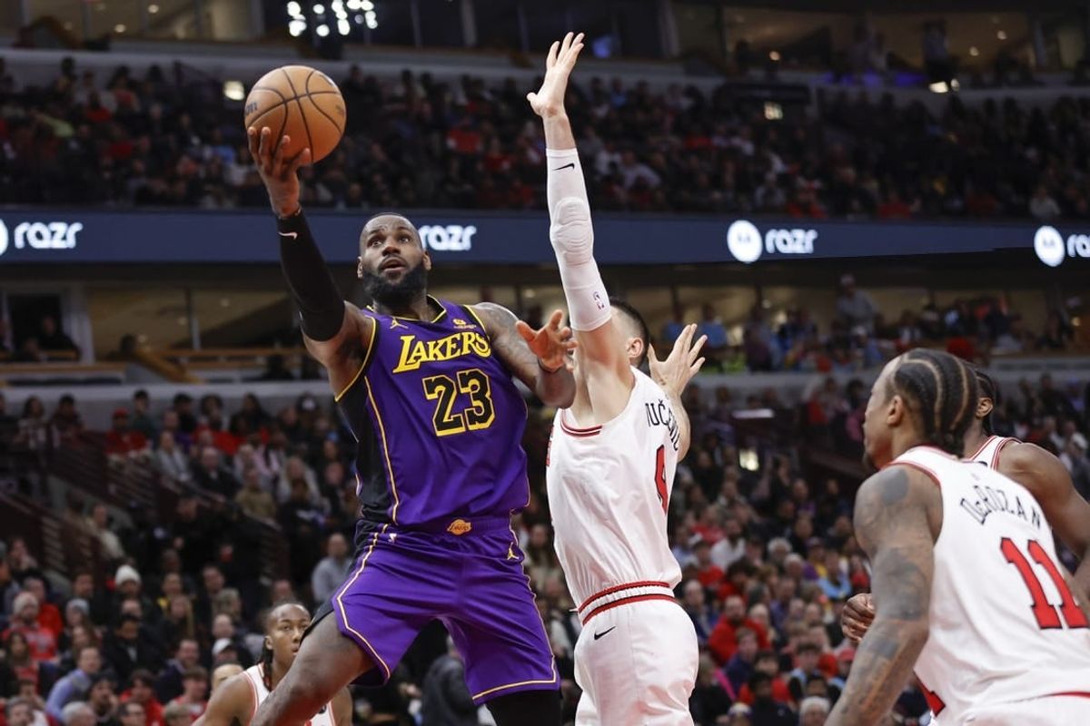 Dec 20, 2023; Chicago, Illinois, USA; Los Angeles Lakers forward LeBron James (23) goes to the basket against Chicago Bulls center Nikola Vucevic (9) during the second half at United Center.