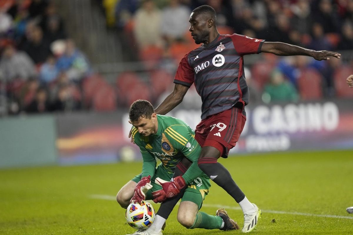 May 11, 2024; Toronto, Ontario, CAN; New York City FC goalkeeper Matt Freese (49) defends against Toronto FC forward Prince Owusu (99) during the second half at BMO Field. Mandatory Credit: John E. Sokolowski-USA TODAY Sports