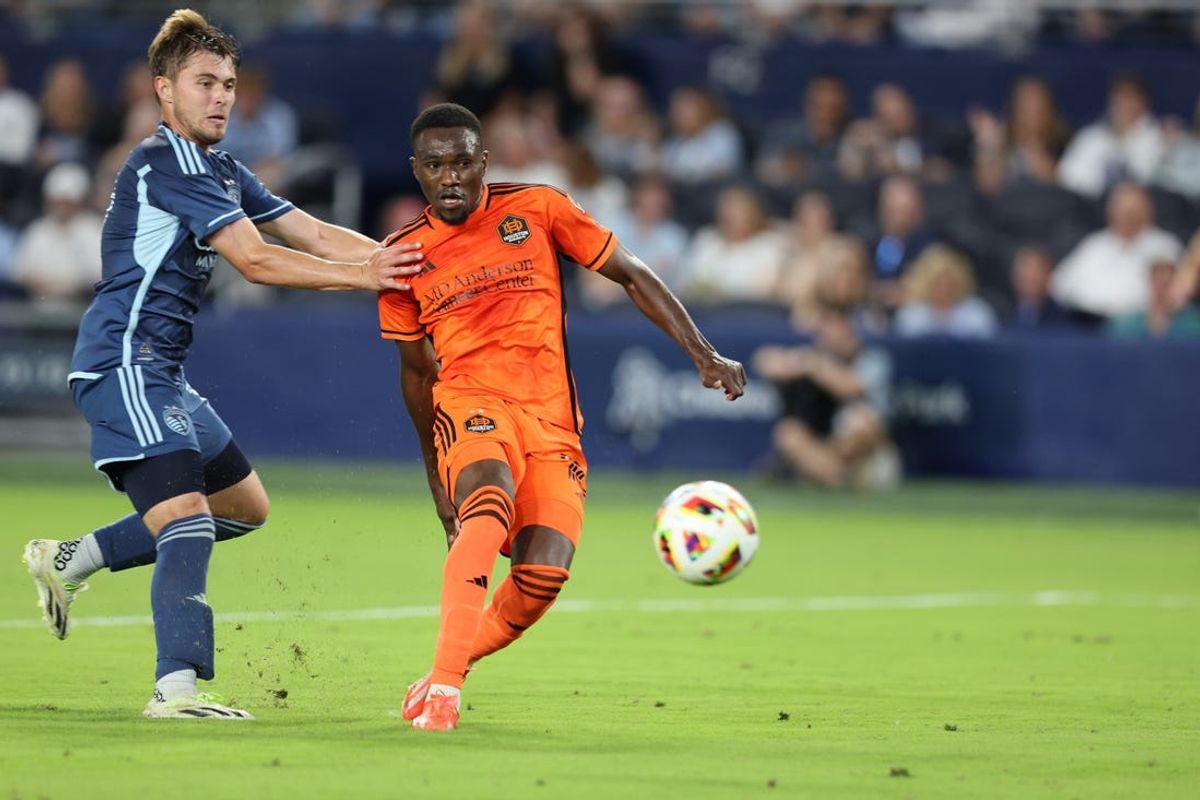 May 11, 2024; Kansas City, Kansas, USA; Houston Dynamo forward Ibrahim Aliyu (18) scores a goal in the second half against the Sporting Kansas City at Children's Mercy Park. Mandatory Credit: William Purnell-USA TODAY Sports
