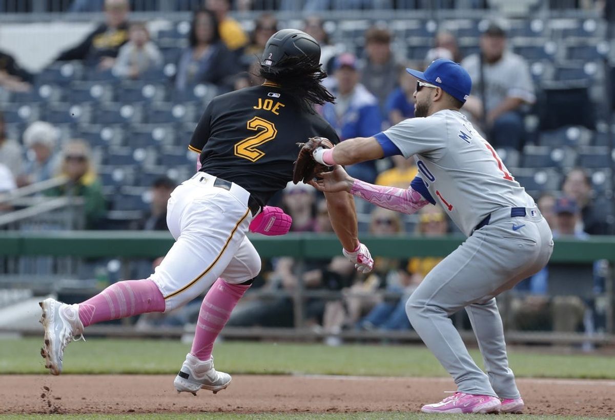 May 12, 2024; Pittsburgh, Pennsylvania, USA;  Chicago Cubs second baseman Nick Madrigal (1) tags Pittsburgh Pirates right fielder Connor Joe (2) out on a caught stealing run down between first and second bases during the fourth inning at PNC Park. Mandatory Credit: Charles LeClaire-USA TODAY Sports