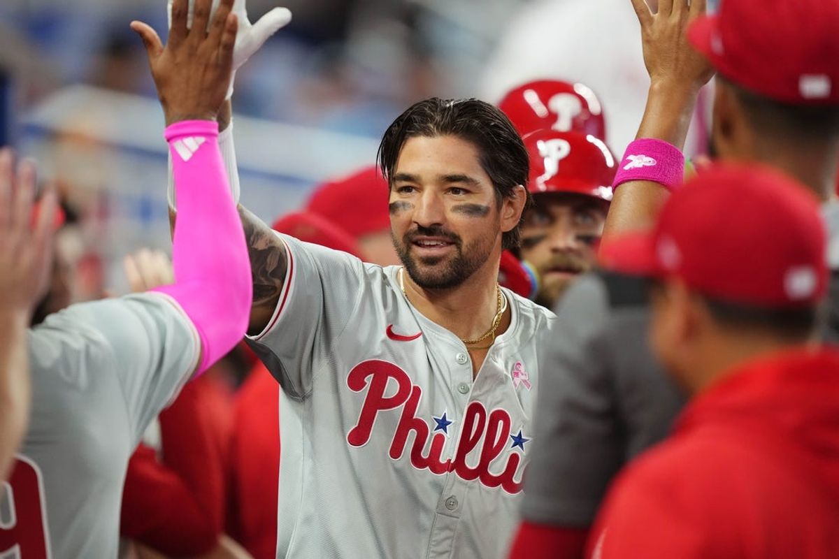 May 12, 2024; Miami, Florida, USA;  Philadelphia Phillies right fielder Nick Castellanos (8) is congratulated by teammates after hitting a three-run home run in the first inning against the Miami Marlins at loanDepot Park. Mandatory Credit: Jim Rassol-USA TODAY Sports