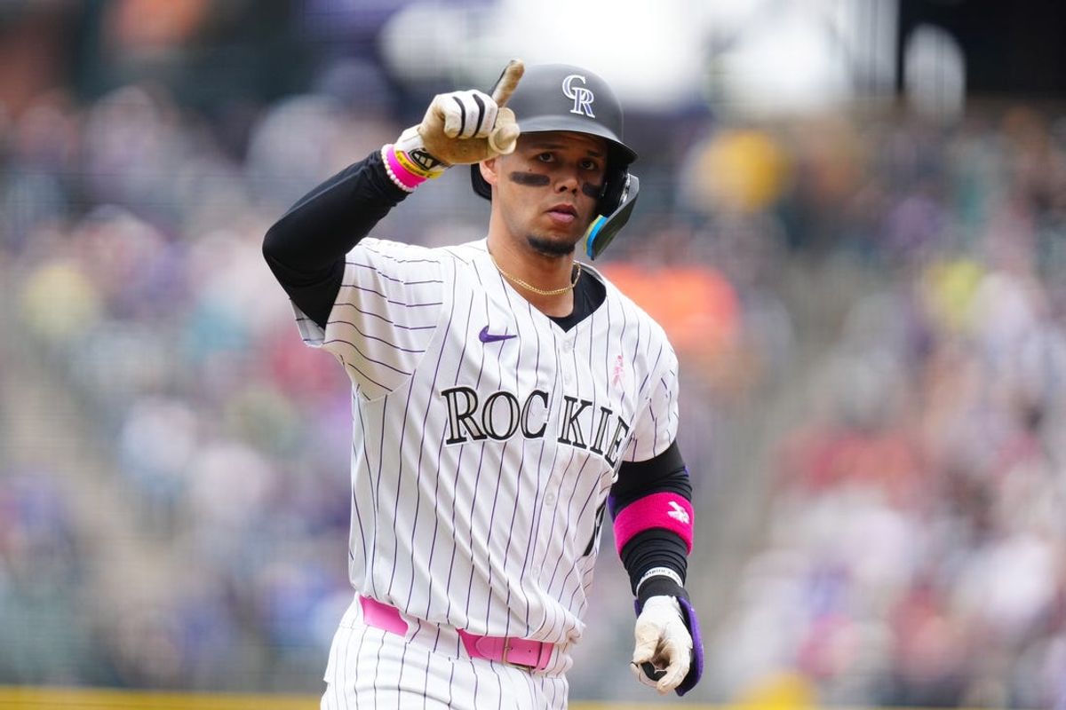 May 12, 2024; Denver, Colorado, USA; Colorado Rockies shortstop Ezequiel Tovar (14) celebrates scoring his two run home run in the first inning against the Texas Rangers at Coors Field. Mandatory Credit: Ron Chenoy-USA TODAY Sports