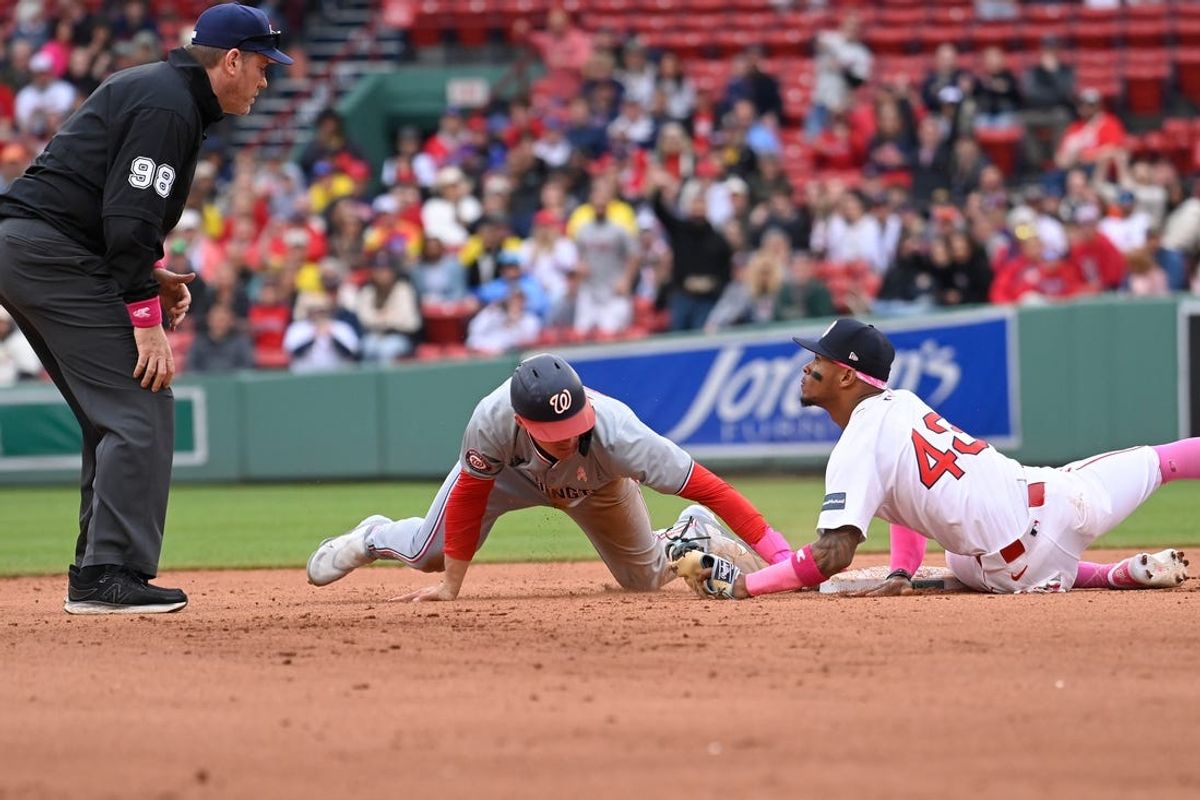 May 12, 2024; Boston, Massachusetts, USA;  Boston Red Sox center fielder Ceddanne Rafaela (43) tags Washington Nationals  Jacob Young (30) out to end the game and beat the Washington Nationals at Fenway Park. Mandatory Credit: Eric Canha-USA TODAY Sports