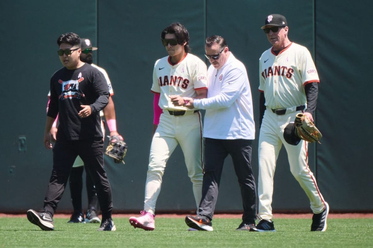 May 12, 2024; San Francisco, California, USA; San Francisco Giants outfielder Jung Hoo Lee (51) walks off the field with an injury accompanied by senior director of athletic training Dave Groeschner (second from right) and manager Bob Melvin (6) (first from right) against the Cincinnati Reds during the first inning at Oracle Park. Mandatory Credit: Robert Edwards-USA TODAY Sports