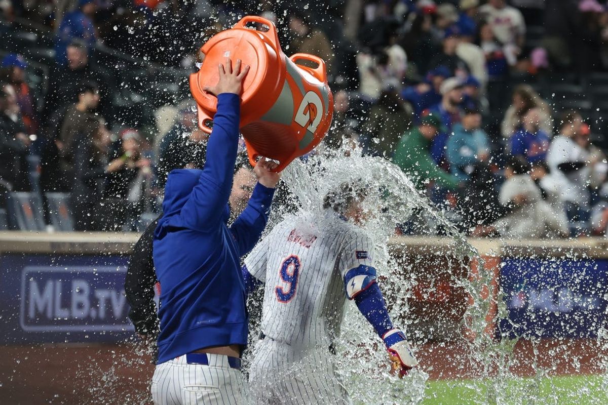 May 12, 2024; New York City, New York, USA; New York Mets left fielder Brandon Nimmo (9) is splashed with a gatorade shower after hitting a walk-off two run home run to defeat the Atlanta Braves at Citi Field. Mandatory Credit: Vincent Carchietta-USA TODAY Sports
