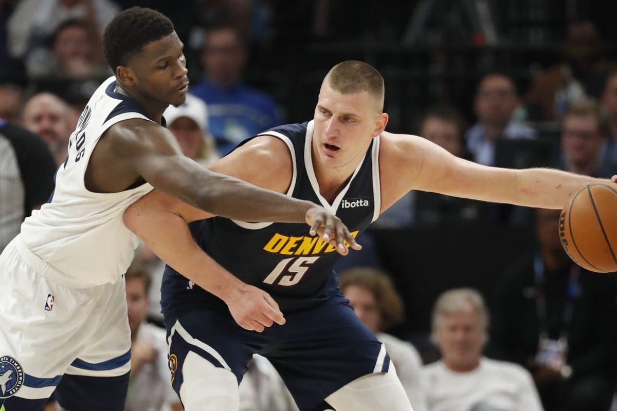 May 12, 2024; Minneapolis, Minnesota, USA; Denver Nuggets center Nikola Jokic (15) works around Minnesota Timberwolves guard Anthony Edwards (5) in the fourth quarter of game four of the second round for the 2024 NBA playoffs at Target Center. Mandatory Credit: Bruce Kluckhohn-USA TODAY Sports