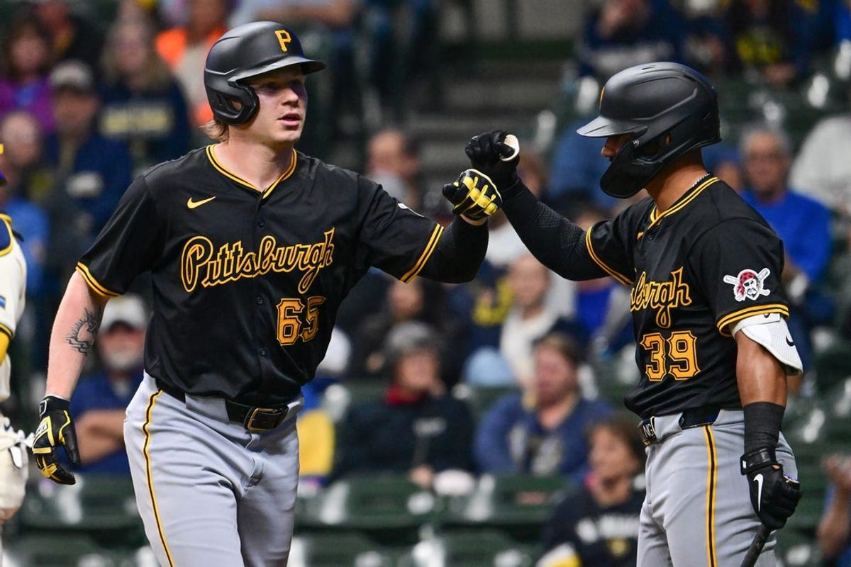 May 13, 2024; Milwaukee, Wisconsin, USA; Pittsburgh Pirates left fielder Jack Suwinski (65) is greeted by second baseman Nick Gonzales (39) after hitting a 2-run home run in the first inning against the Milwaukee Brewers at American Family Field. Mandatory Credit: Benny Sieu-USA TODAY Sports