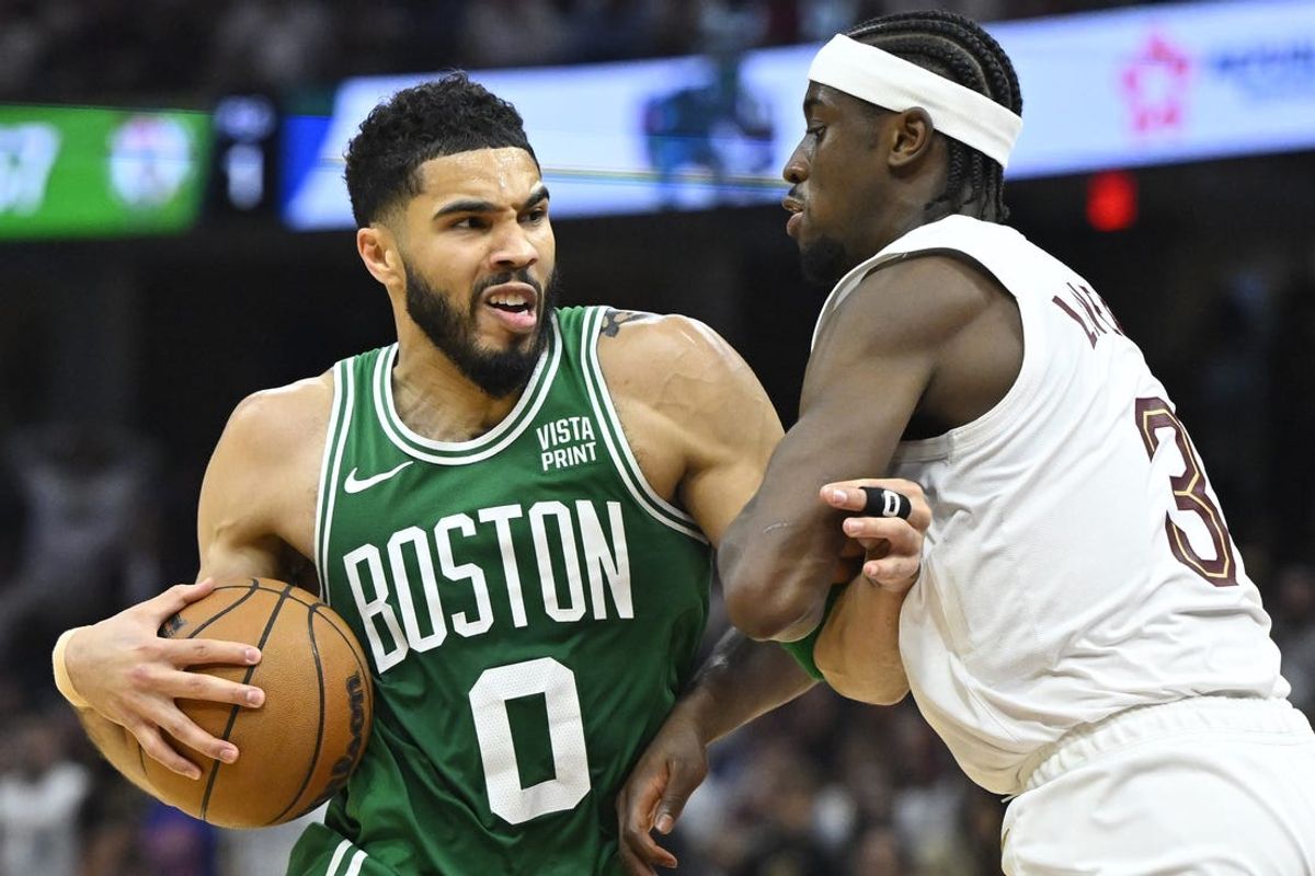 May 13, 2024; Cleveland, Ohio, USA; Boston Celtics forward Jayson Tatum (0) drives against Cleveland Cavaliers guard Caris LeVert (3) in the second quarter of game four of the second round for the 2024 NBA playoffs at Rocket Mortgage FieldHouse. Mandatory Credit: David Richard-USA TODAY Sports