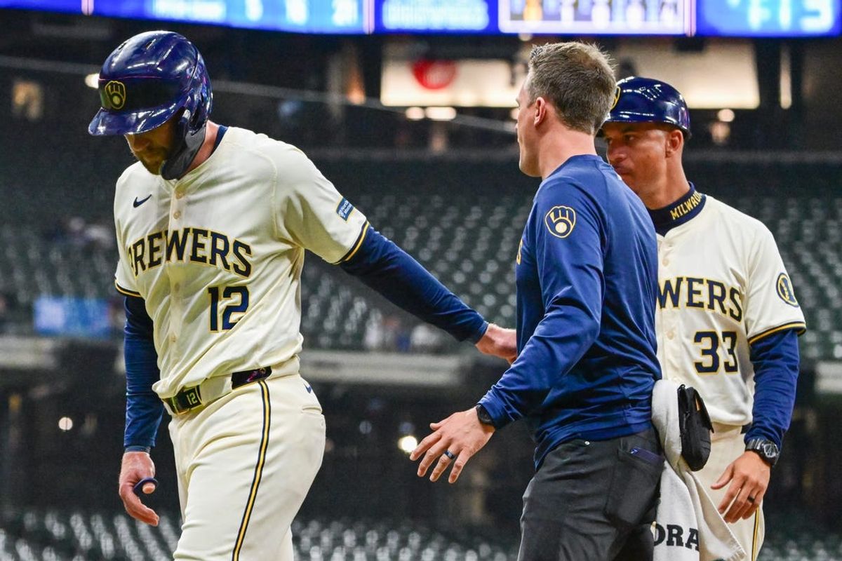 May 13, 2024; Milwaukee, Wisconsin, USA; Milwaukee Brewers first baseman Rhys Hoskins (12) leaves the game with an injury in the second inning against the Pittsburgh Pirates at American Family Field. Mandatory Credit: Benny Sieu-USA TODAY Sports