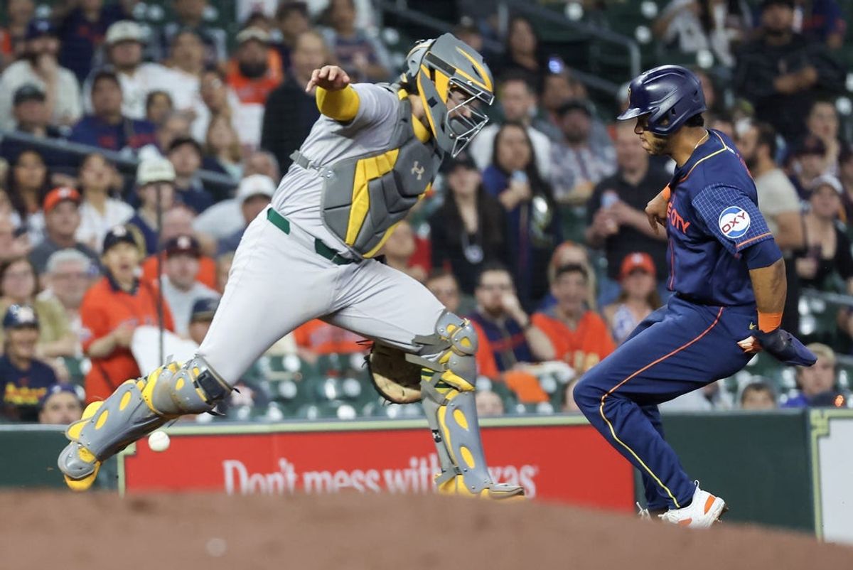 May 13, 2024; Houston, Texas, USA; Houston Astros shortstop Jeremy Peña (3) avoids Oakland Athletics center fielder Shea Langeliers (23) at third base and scores in the second inning  at Minute Maid Park. Mandatory Credit: Thomas Shea-USA TODAY Sports