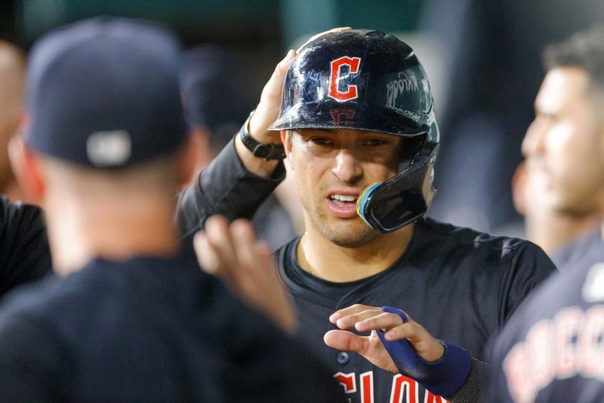 May 13, 2024; Arlington, Texas, USA;  Cleveland Guardians outfielder Tyler Freeman (2) is patted on the head after scoring a run in the eighth inning against the Texas Rangers at Globe Life Field. Mandatory Credit: Andrew Dieb-USA TODAY Sports