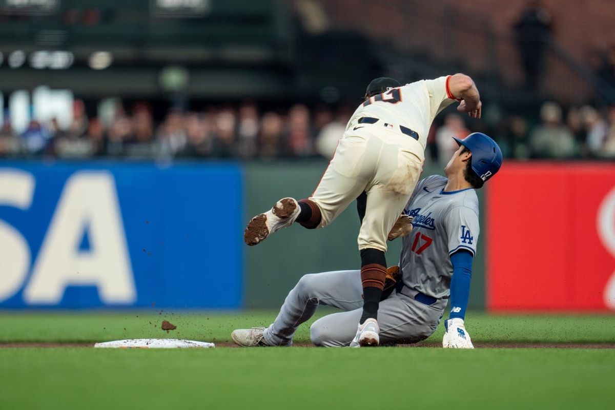 May 13, 2024; San Francisco, California, USA; Los Angeles Dodgers designated hitter Shohei Ohtani (17) steal second base against San Francisco Giants shortstop Casey Schmitt (10) during the third inning at Oracle Park. Mandatory Credit: Neville E. Guard-USA TODAY Sports