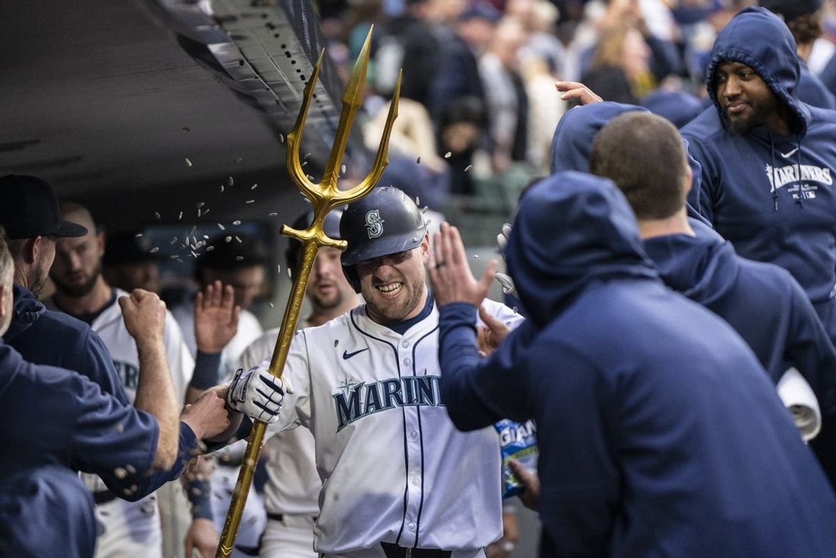 May 13, 2024; Seattle, Washington, USA; Seattle Mariners left fielder Luke Raley (20) celebrates in the dugout after hitting a two-run home run during the second inning against the Kansas City Royals at T-Mobile Park. Mandatory Credit: Stephen Brashear-USA TODAY Sports