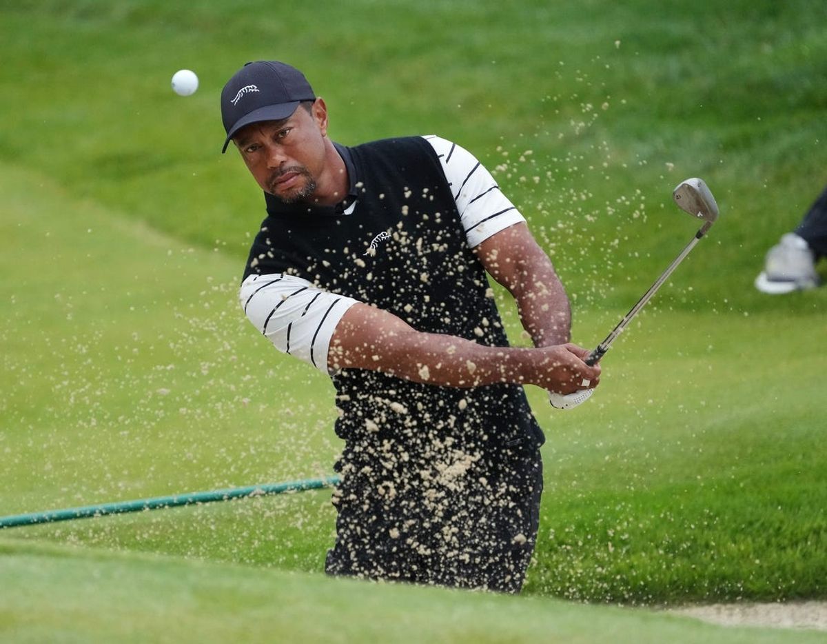 Tiger Woods htis a bunker shot on the 3rd green during a practice round in the PGA Championship at the Valhalla Golf Course in Louisville, Ky. on May. 14, 2024.