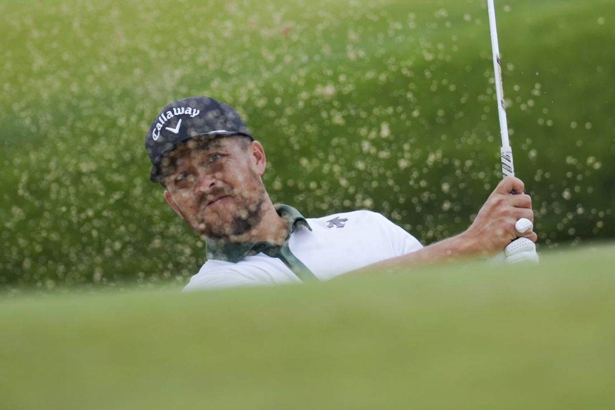 May 14, 2024; Louisville, Kentucky, USA; Xander Schauffele plays a shot from a bunker on the 18th green during a practice round for the PGA Championship golf tournament at Valhalla Golf Club. Mandatory Credit: Aaron Doster-USA TODAY Sports