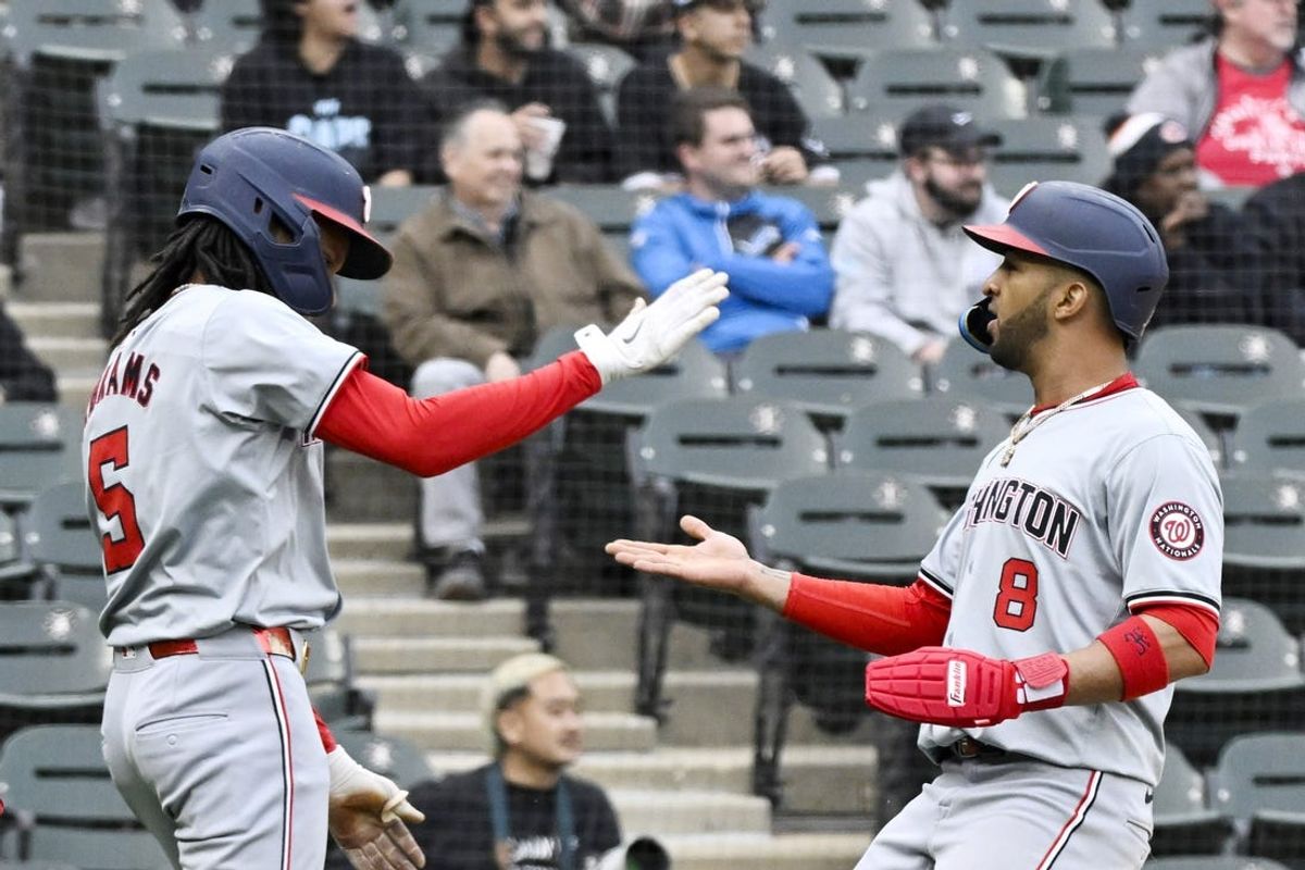 May 14, 2024; Chicago, Illinois, USA; Washington Nationals shortstop CJ Abrams (5) and outfielder Eddie Rosario (8) celebrate after scoring against the Chicago White Sox during the fifth inning at Guaranteed Rate Field. Mandatory Credit: Matt Marton-USA TODAY Sports