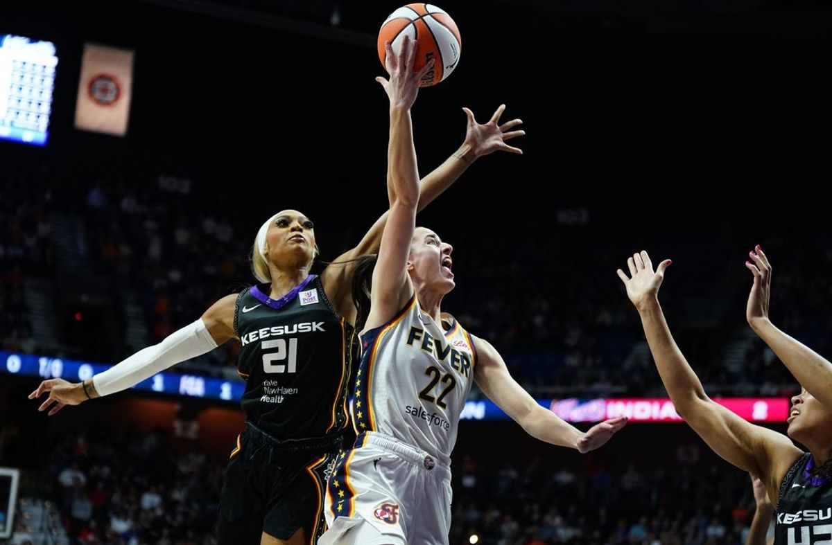 May 14, 2024; Uncasville, Connecticut, USA; Indiana Fever guard Caitlin Clark (22) shoots the ball against Connecticut Sun guard DiJonai Carrington (21) in the first quarter at Mohegan Sun Arena. Mandatory Credit: David Butler II-USA TODAY Sports