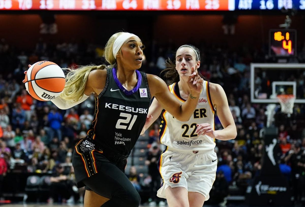 May 14, 2024; Uncasville, Connecticut, USA; Connecticut Sun guard DiJonai Carrington (21) drives the ball against Indiana Fever guard Caitlin Clark (22) in the second half at Mohegan Sun Arena. Mandatory Credit: David Butler II-USA TODAY Sports
