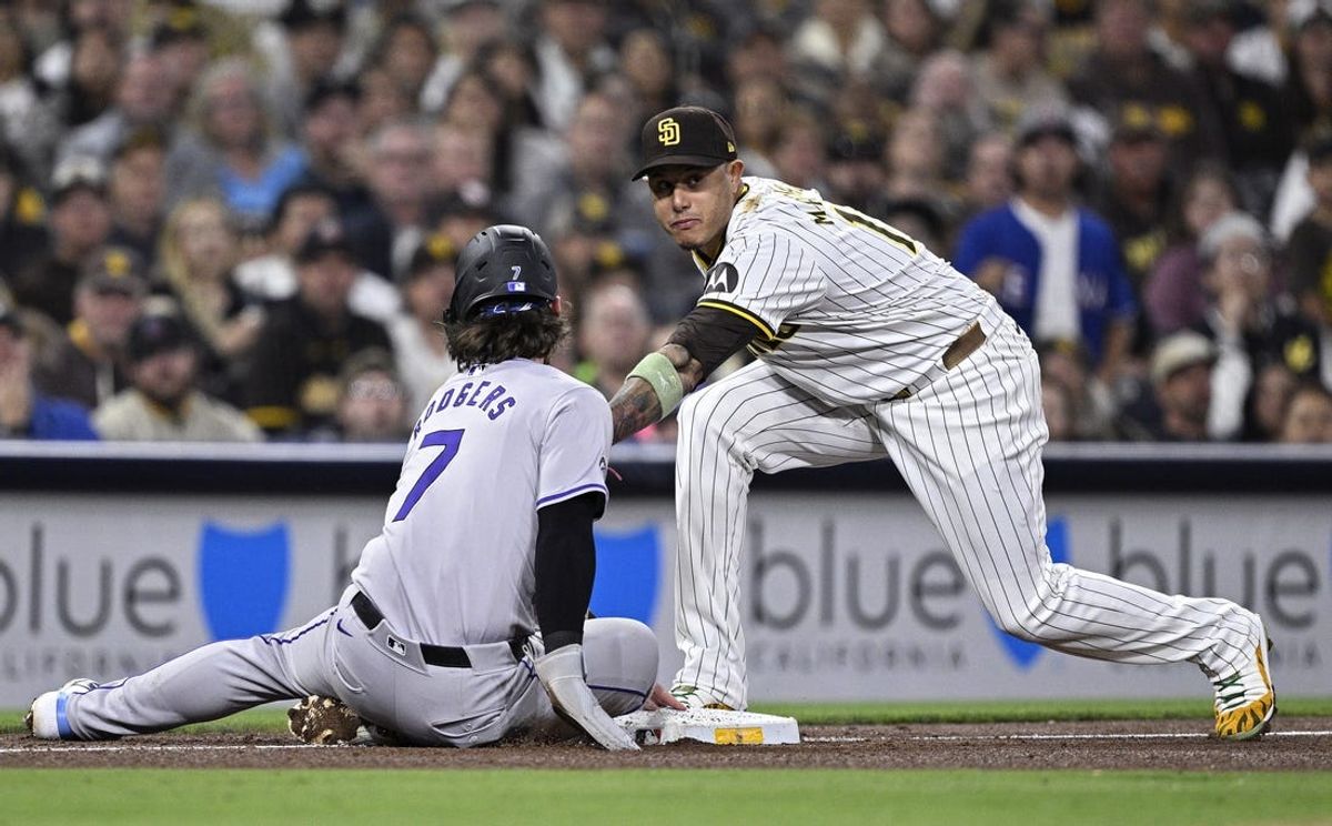 May 13, 2024; San Diego, California, USA; Colorado Rockies second baseman Brendan Rodgers (7) slides into third base ahead of the tag by San Diego Padres third baseman Manny Machado (13) during the sixth inning at Petco Park. Mandatory Credit: Orlando Ramirez-USA TODAY Sports