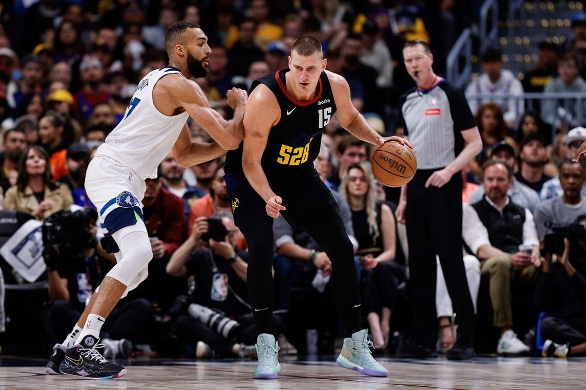 May 14, 2024; Denver, Colorado, USA; Denver Nuggets center Nikola Jokic (15) controls the ball as Minnesota Timberwolves center Rudy Gobert (27) guards in the first quarter during game five of the second round for the 2024 NBA playoffs at Ball Arena. Mandatory Credit: Isaiah J. Downing-USA TODAY Sports