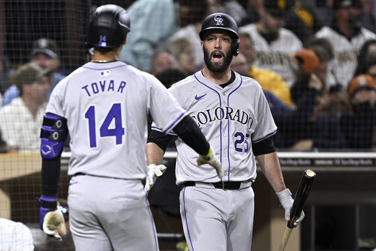 May 13, 2024; San Diego, California, USA; Colorado Rockies shortstop Ezequiel Tovar (14) is congratulated by catcher Jacob Stallings (25) after hitting a home run during the seventh inning against the San Diego Padres at Petco Park. Mandatory Credit: Orlando Ramirez-USA TODAY Sports