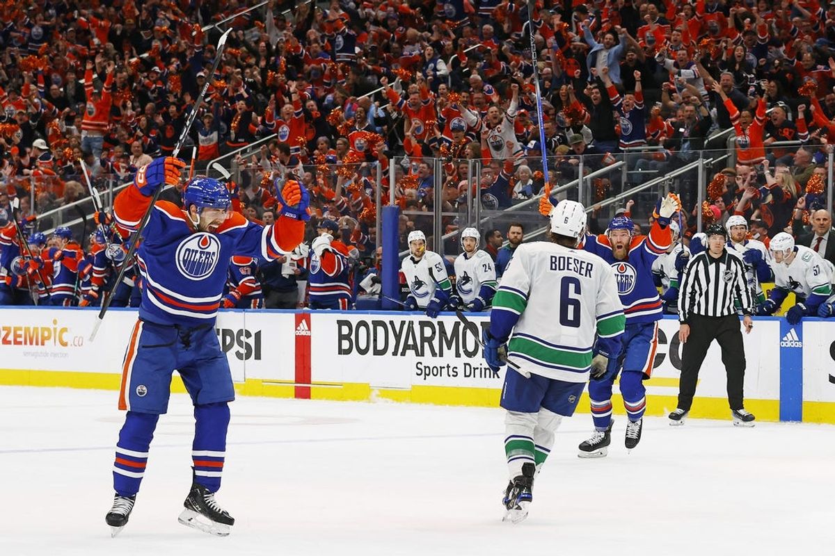 May 14, 2024; Edmonton, Alberta, CAN; Edmonton Oilers defensemen Evan Bouchard (2) celebrates after scoring a goal during the third period against the Vancouver Canucks in game four of the second round of the 2024 Stanley Cup Playoffs at Rogers Place. Mandatory Credit: Perry Nelson-USA TODAY Sports