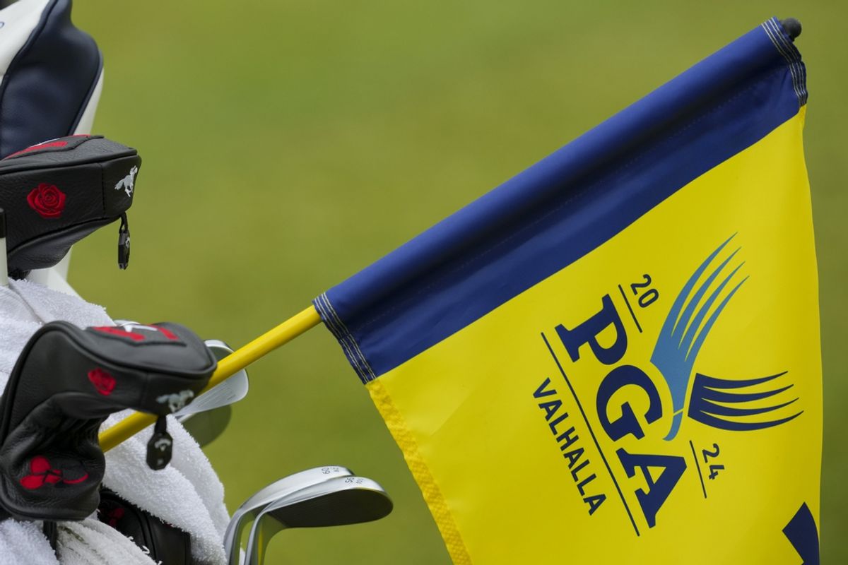 May 15, 2024; Louisville, Kentucky, USA; The tournament logo is seen on the pin flag of the 10th green, as it rests on a golfer’s bag during a practice round for the PGA Championship golf tournament at Valhalla Golf Club. Mandatory Credit: Aaron Doster-USA TODAY Sports