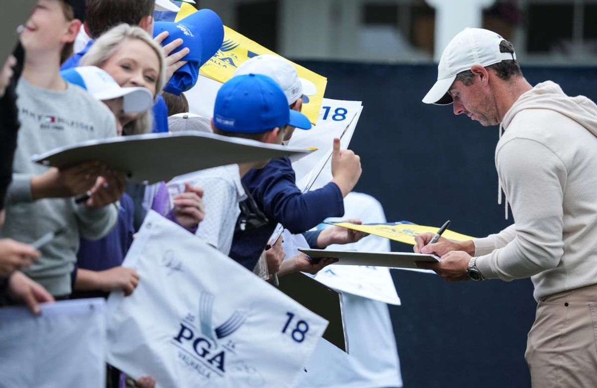 Rory McIlroy signs autographs for the packed crowd outside the 18th green at the 2024 PGA Championship Wednesday at Valhalla Golf Course in Louisville, Kentucky. May 15, 2024.