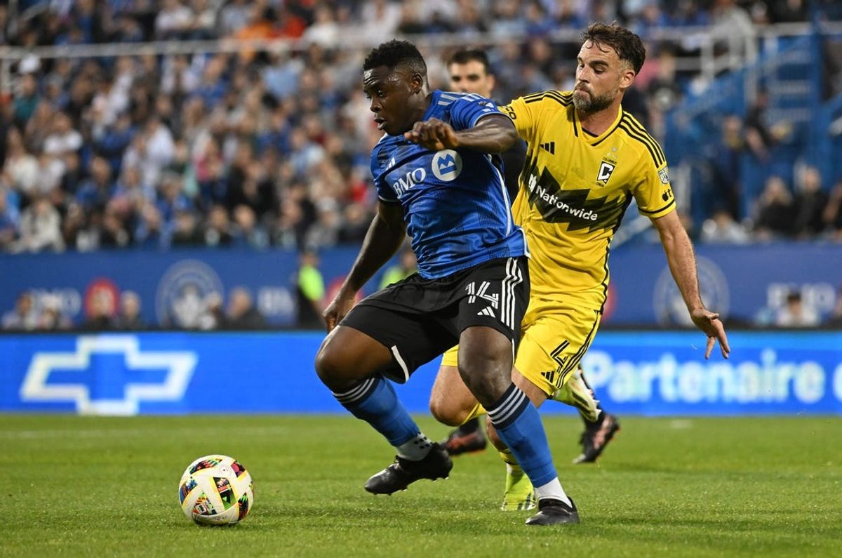 May 15, 2024; Montreal, Quebec, CAN; CF Montreal forward Sunusi Ibrahim (14) dribbles against Columbus Crew defender Rudy Camacho (4) during the first half at Stade Saputo. Mandatory Credit: David Kirouac-USA TODAY Sports