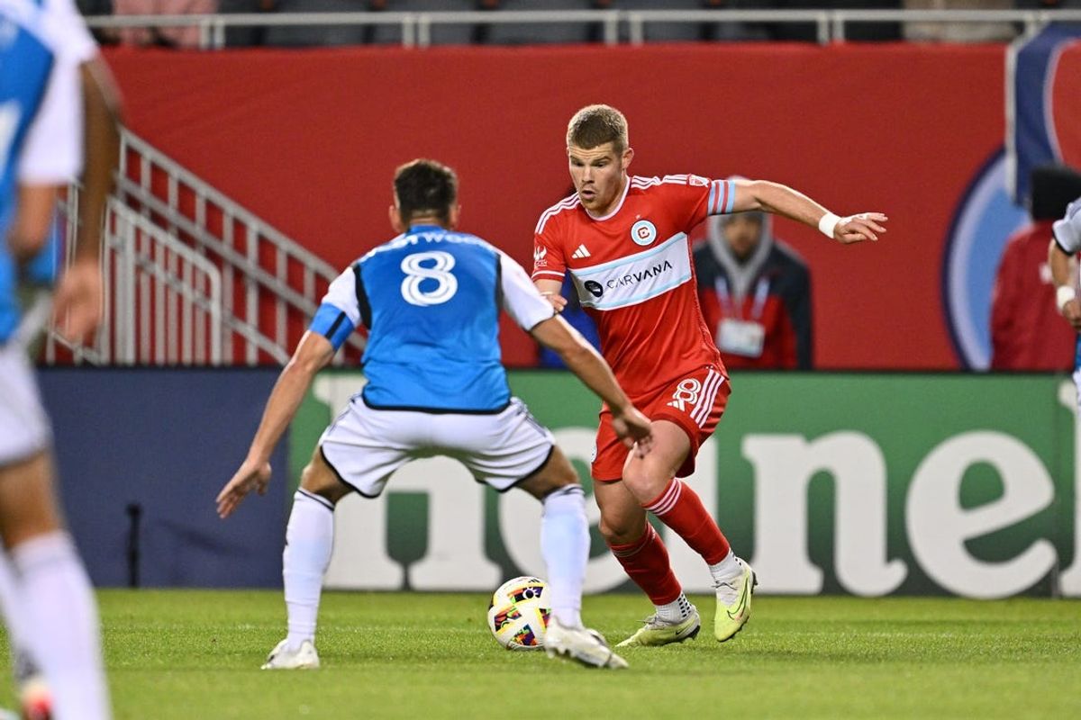 May 15, 2024; Chicago, Illinois, USA; Chicago Fire FC forward Chris Mueller (8) dribbles against Charlotte FC midfielder Ashley Westwood (8) during the second half at Soldier Field. Mandatory Credit: Jamie Sabau-USA TODAY Sports
