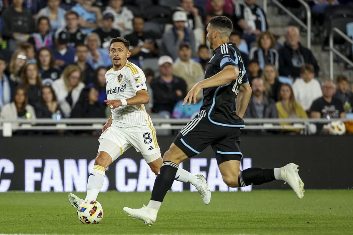 May 15, 2024; Saint Paul, Minnesota, USA; LA Galaxy midfielder Mark Delgado (8) and Minnesota United forward Michael Boxall (15) battle for the ball during the second half at Allianz Field. Mandatory Credit: Matt Krohn-USA TODAY Sports