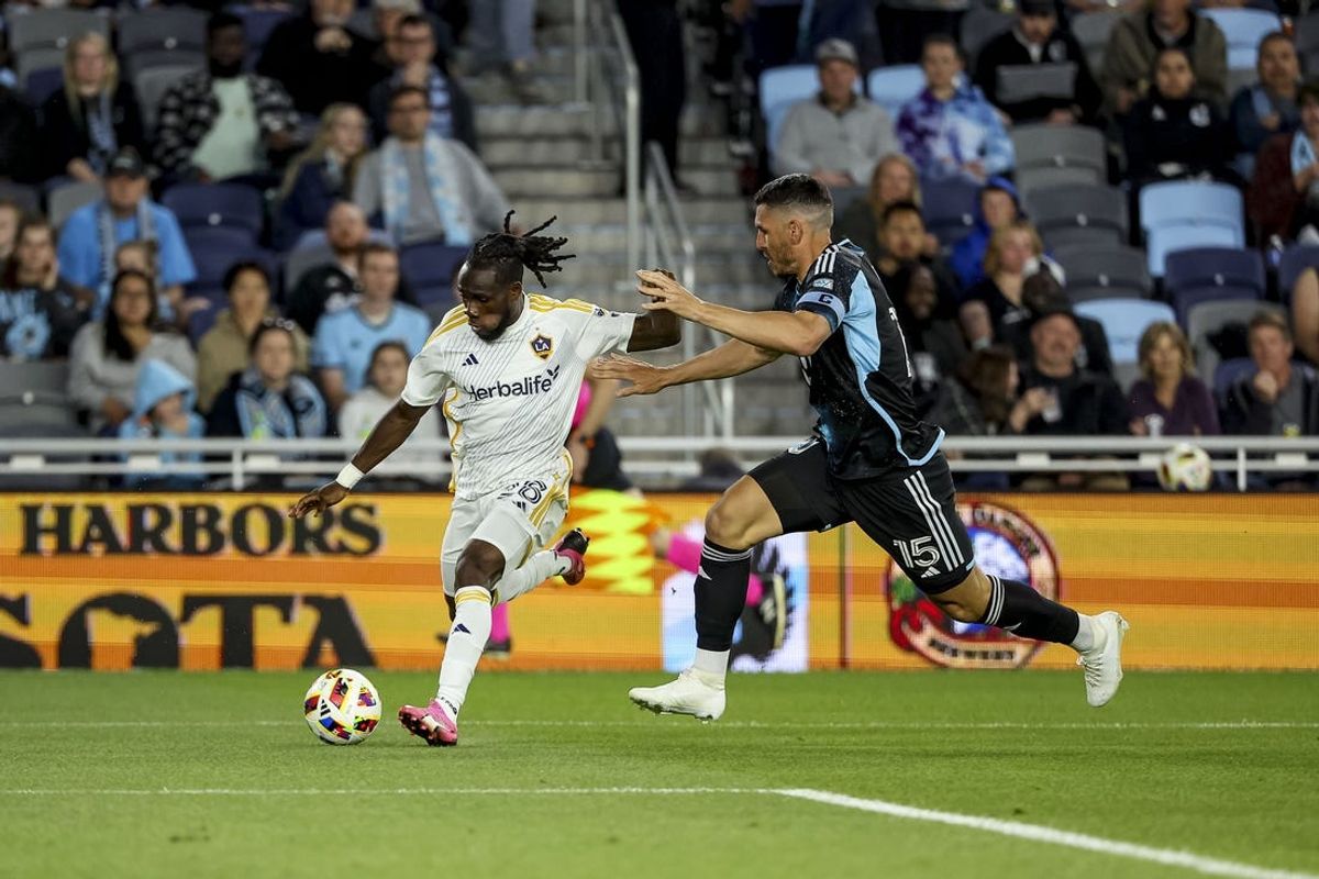 May 15, 2024; Saint Paul, Minnesota, USA; LA Galaxy forward Joseph Paintsil (28) and Minnesota United forward Michael Boxall (15) battle for the ball during the second half at Allianz Field. Mandatory Credit: Matt Krohn-USA TODAY Sports