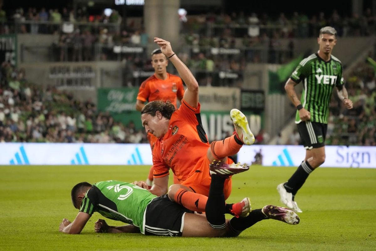 May 15, 2024; Austin, Texas, USA; Houston Dynamo FC defender Tate Schmitt (22) and Austin FC midfielder Owen Wolff (33) collide in the second half at Q2 Stadium. Mandatory Credit: Scott Wachter-USA TODAY Sports