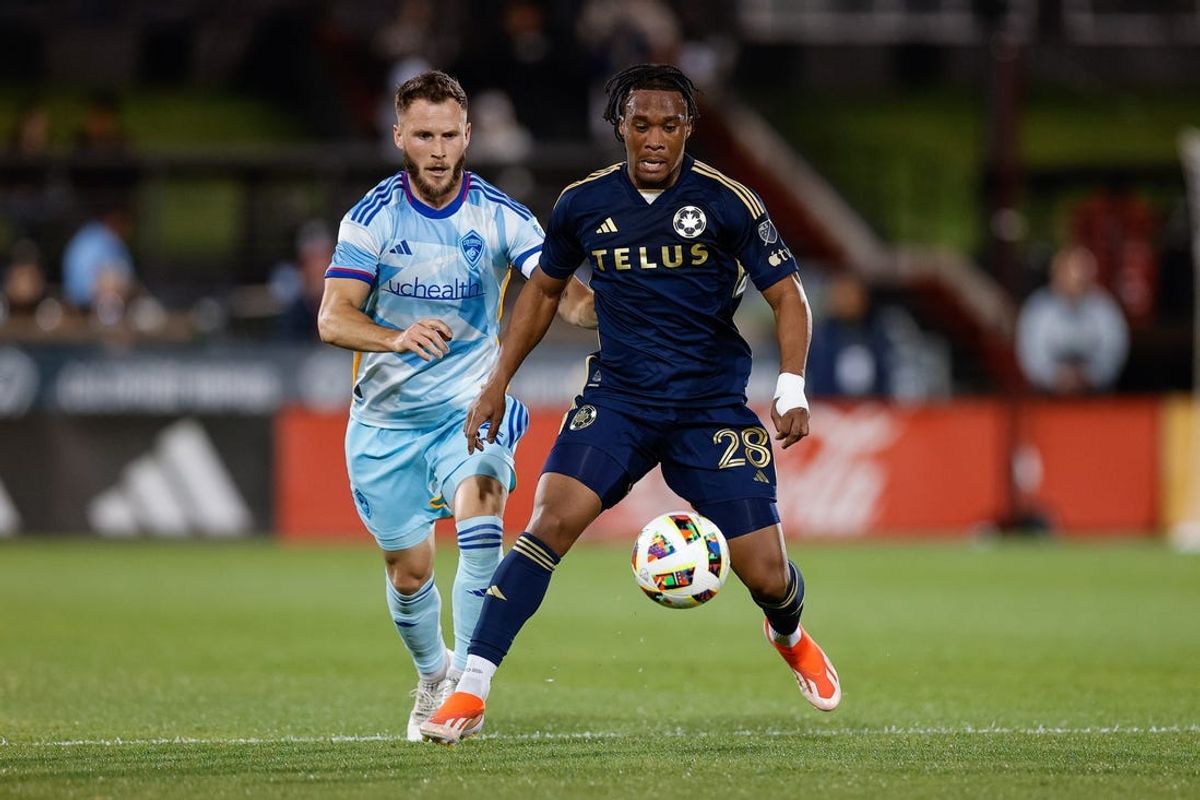 May 15, 2024; Commerce City, Colorado, USA; Colorado Rapids defender Keegan Rosenberry (2) and Vancouver Whitecaps FC forward Levonte Johnson (28) battle for the ball in the first half at Dick's Sporting Goods Park. Mandatory Credit: Isaiah J. Downing-USA TODAY Sports