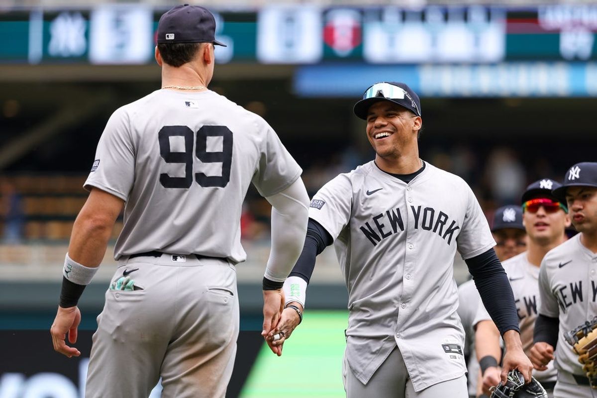 May 16, 2024; Minneapolis, Minnesota, USA; New York Yankees right fielder Juan Soto (22) and designated hitter Aaron Judge (99) celebrate the win after the game against the Minnesota Twins at Target Field. Mandatory Credit: Matt Krohn-USA TODAY Sports