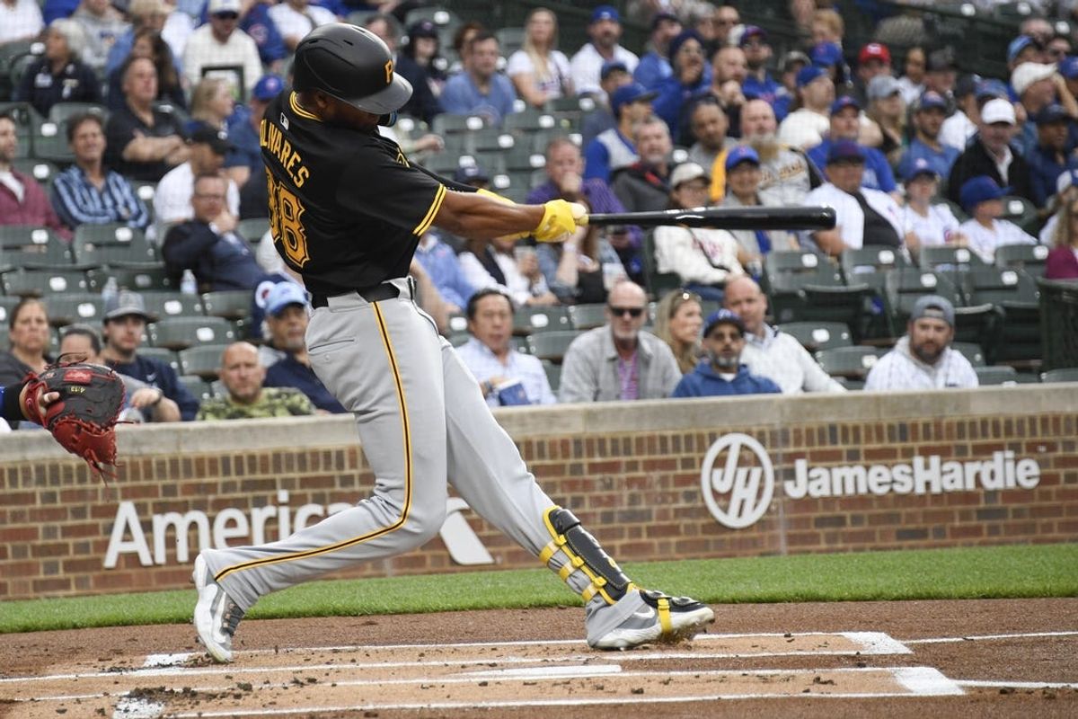 May 16, 2024; Chicago, Illinois, USA;  Pittsburgh Pirates outfielder Edward Olivares (38) hits a two run home run against the Chicago Cubs during the first inning at Wrigley Field. Mandatory Credit: Matt Marton-USA TODAY Sports