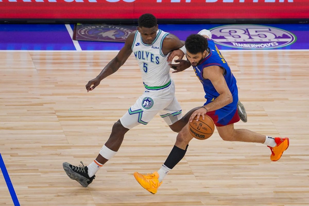 May 16, 2024; Minneapolis, Minnesota, USA; Minnesota Timberwolves guard Anthony Edwards (5) defends Denver Nuggets guard Jamal Murray (27) in the first quarter during game six of the second round for the 2024 NBA playoffs at Target Center. Mandatory Credit: Brad Rempel-USA TODAY Sports