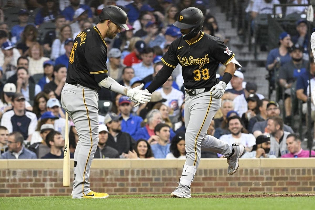 May 16, 2024; Chicago, Illinois, USA;  Pittsburgh Pirates second base Nick Gonzales (39) celebrates with catcher Yasmani Grandal (6) after hitting a home run against the Chicago Cubs during the fourth inning at Wrigley Field. Mandatory Credit: Matt Marton-USA TODAY Sports