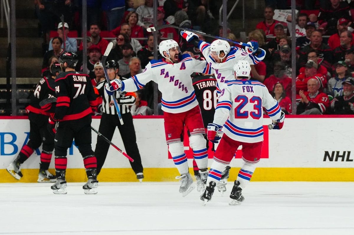 May 16, 2024; Raleigh, North Carolina, USA; New York Rangers left wing Chris Kreider (20) celebrates his goal with left wing Artemi Panarin (10) and  defenseman Adam Fox (23) against the Carolina Hurricanes during the third period in game six of the second round of the 2024 Stanley Cup Playoffs at PNC Arena. Mandatory Credit: James Guillory-USA TODAY Sports