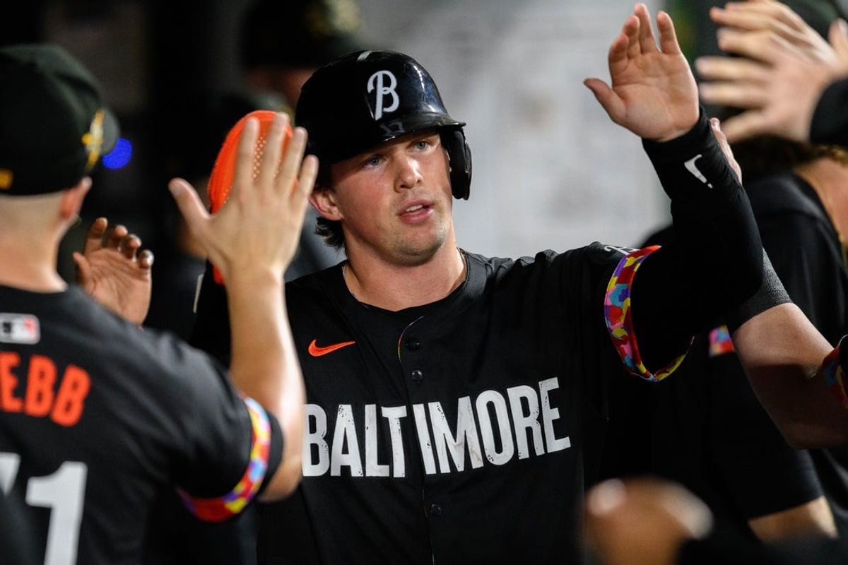 May 17, 2024; Baltimore, Maryland, USA; Baltimore Orioles catcher Adley Rutschman (35) celebrates with teammates after scoring during the seventh inning against the Seattle Mariners at Oriole Park at Camden Yards. Mandatory Credit: Reggie Hildred-USA TODAY Sports