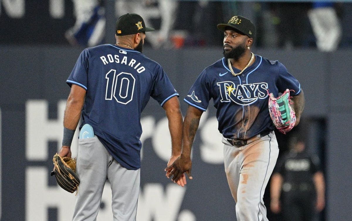 May 17, 2024; Toronto, Ontario, CAN;  Tampa Bay Rays left fielder Randy Arozarena (56) and shortstop Amed Rosario (10) celebrate a win over the Toronto Blue Jays at Rogers Centre. Mandatory Credit: Dan Hamilton-USA TODAY Sports