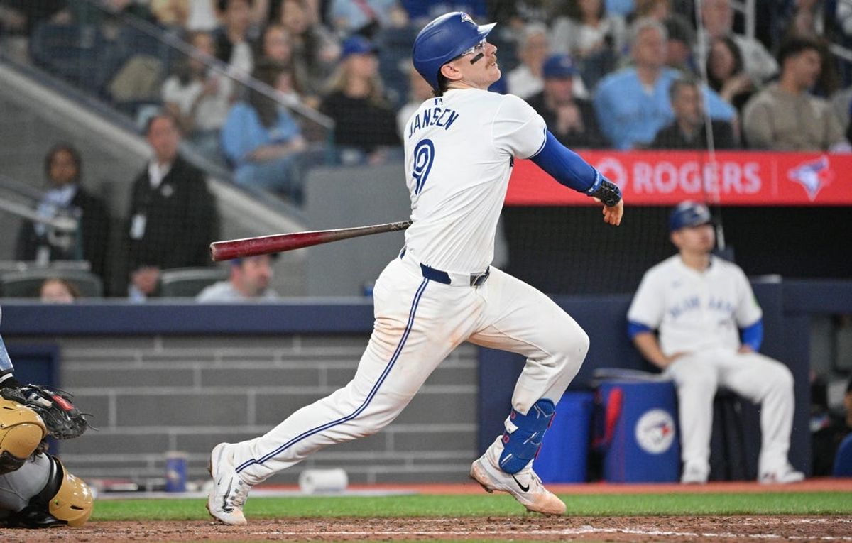 May 17, 2024; Toronto, Ontario, CAN;  Toronto Blue Jays catcher Danny Jansen (9) hits a single against the Tampa Bay Rays in the eighth inning at Rogers Centre. Mandatory Credit: Dan Hamilton-USA TODAY Sports