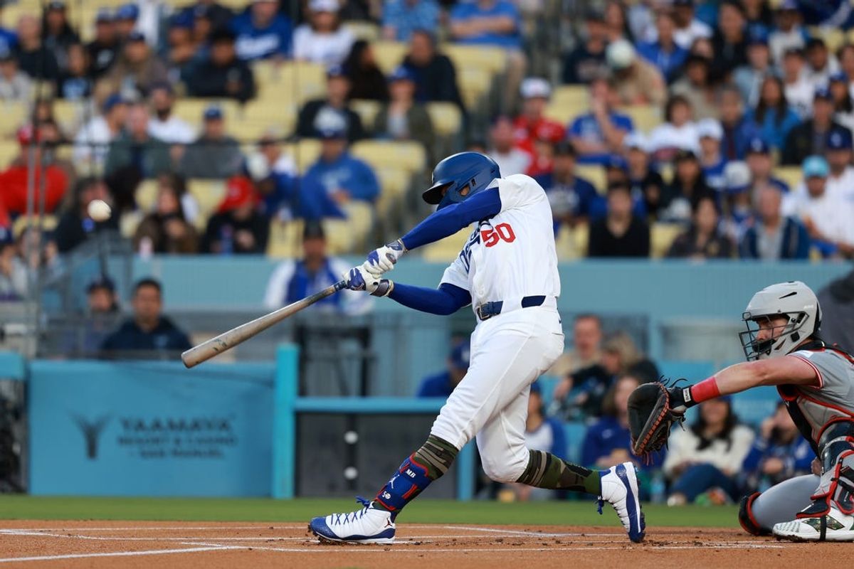 May 17, 2024; Los Angeles, California, USA;  Los Angeles Dodgers shortstop Mookie Betts (50) hits a home run during the first inning against the Cincinnati Reds at Dodger Stadium. Mandatory Credit: Kiyoshi Mio-USA TODAY Sports